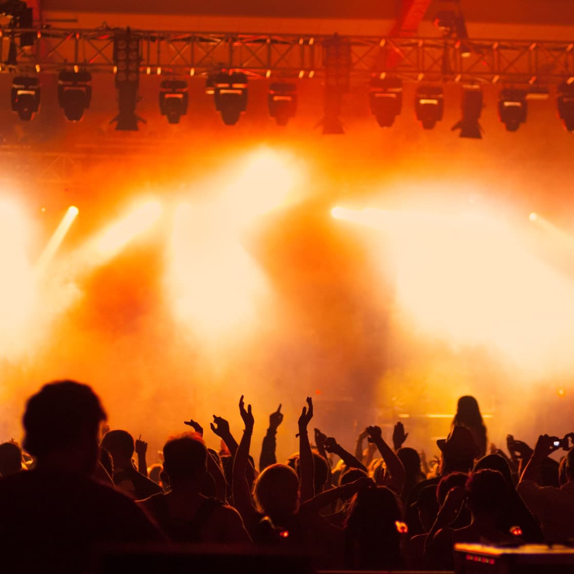 Crowd enjoying a concert with stage lighting