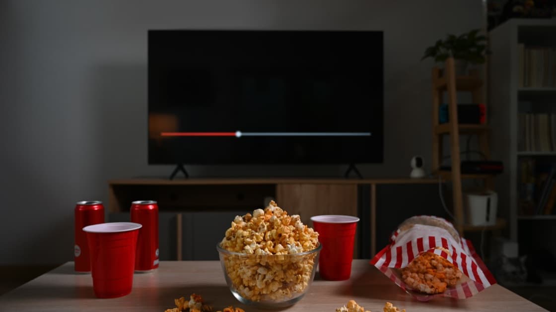 Popcorn and drinks in front of a television