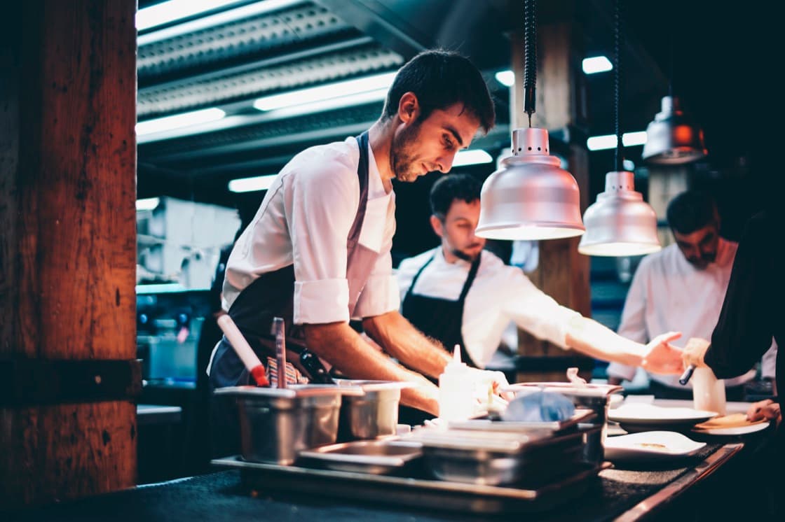 Chef plating food in a restaurant kitchen